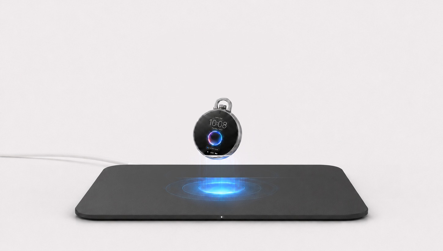 Epoch One leaning slightly while charging above the center of a thin, dark matte, six-inch square wireless charging pad.